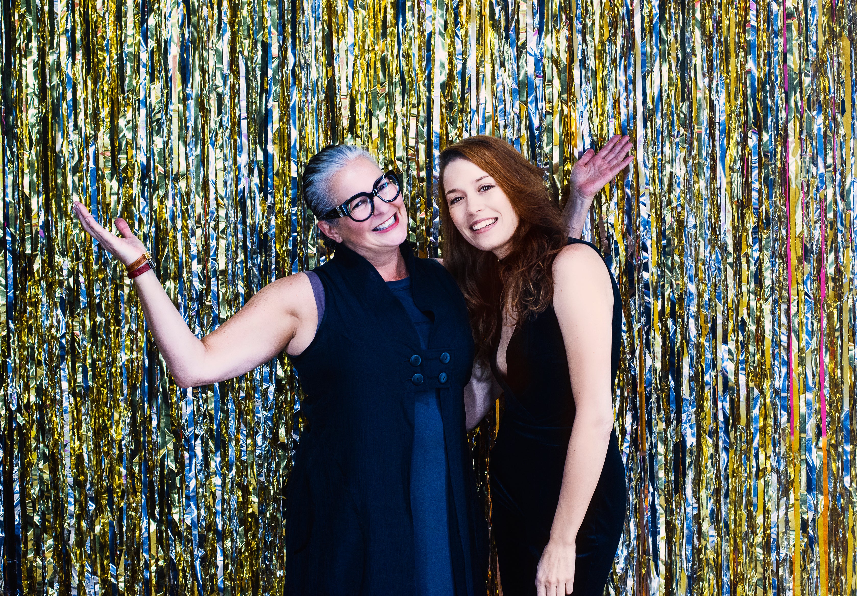 files/women-pose-in-front-of-silver-and-gold-metallic-streamers.jpg
